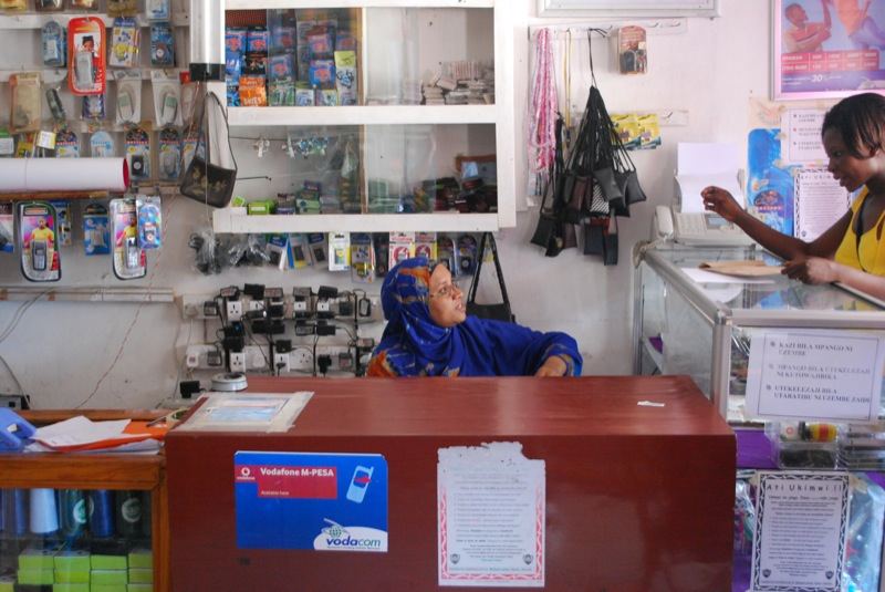 Mobile Remittance Corridors Push Costs Toward Target People using mobile phones outdoors